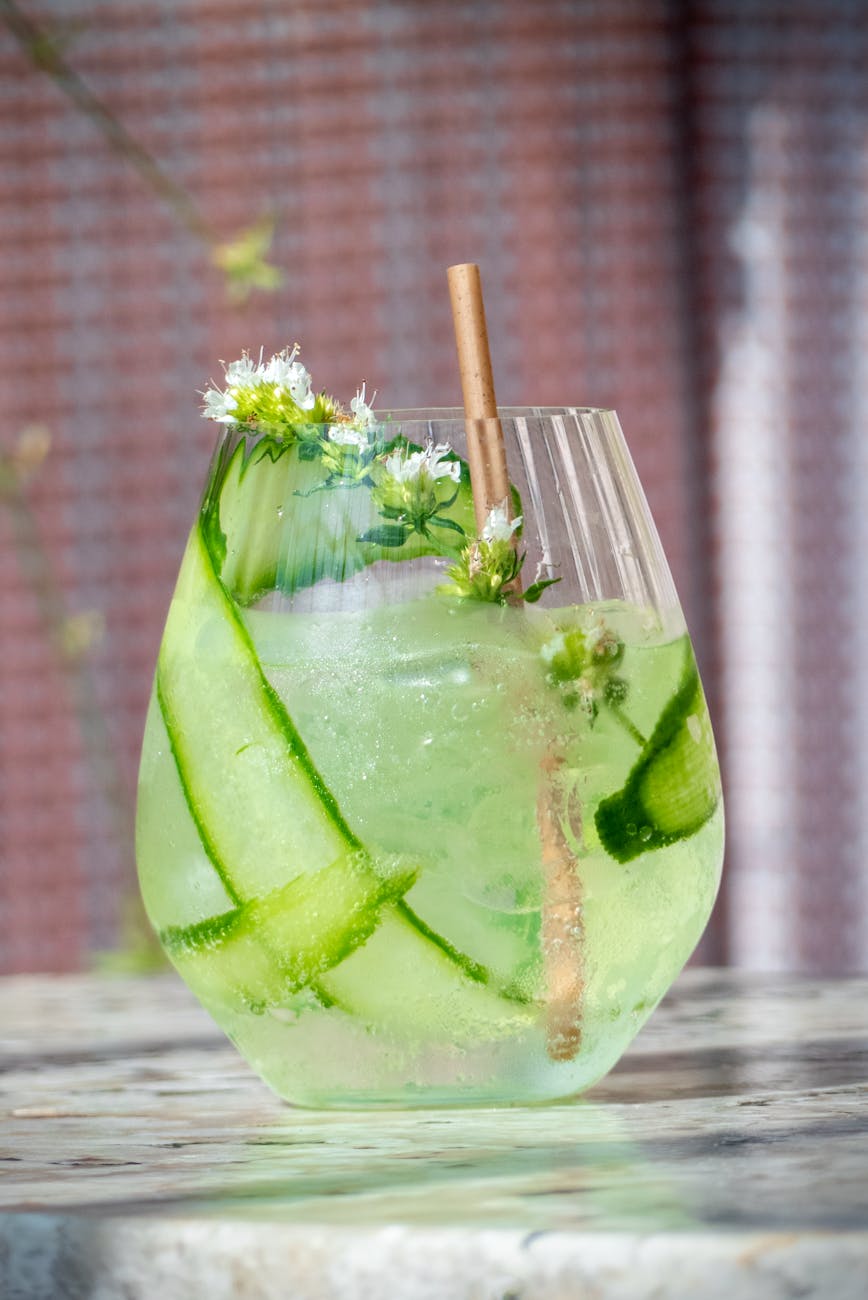 refreshing cucumber cocktail with floral garnish